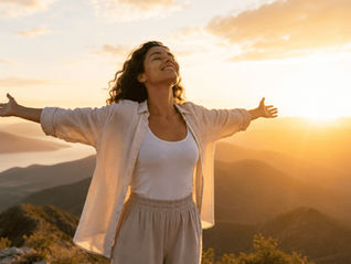 Person standing in sunlight with open arms, symbolizing self-acceptance and freedom