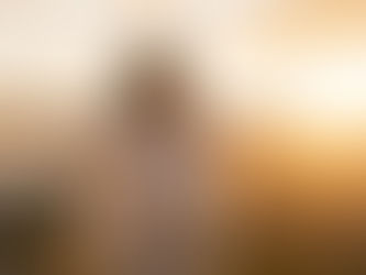 Person standing in sunlight with open arms, symbolizing self-acceptance and freedom