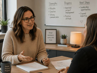 Supervisor giving performance review in a supportive one-on-one meeting setting.