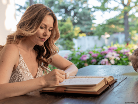 Writer journaling emotional thoughts in soft lighting