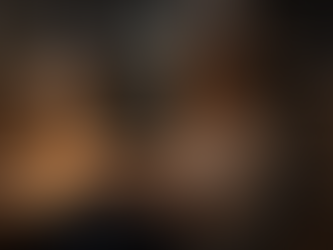 A supervisor sitting quietly with a notepad, reflecting after a long day in a dim office