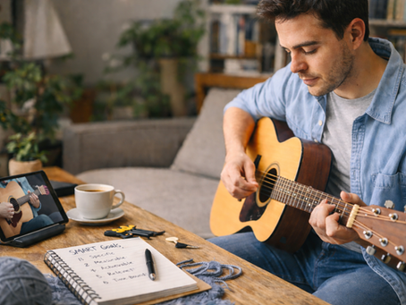 A person practicing a hobby calmly with a notebook and learning materials nearby, symbolizing learning a new skill or hobby using SMART goals.