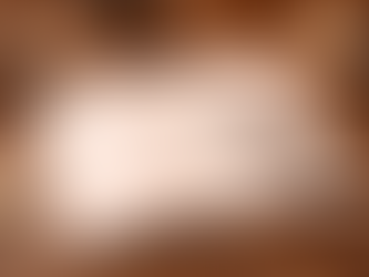 Eye-level view of a journal open on a wooden table with a pen resting on the page