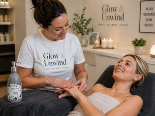 Glow and Unwind therapist using hand lotion on lady client