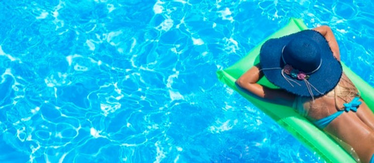 Woman floating in pool 