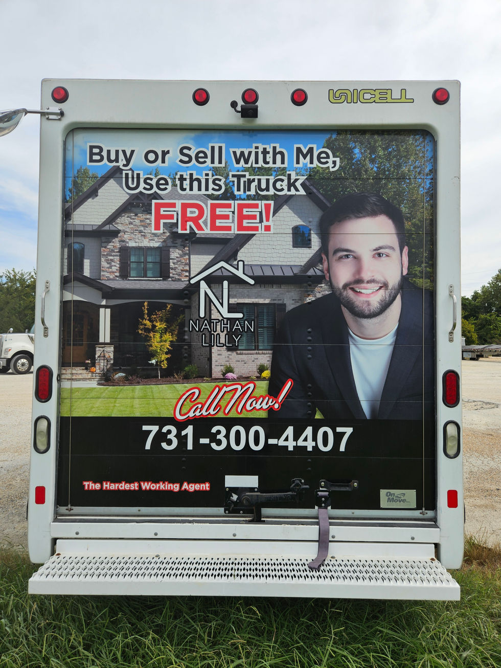Rear view of the Lily Realty box truck in Jackson, TN, showing old branding that was removed during the on-site rebranding project