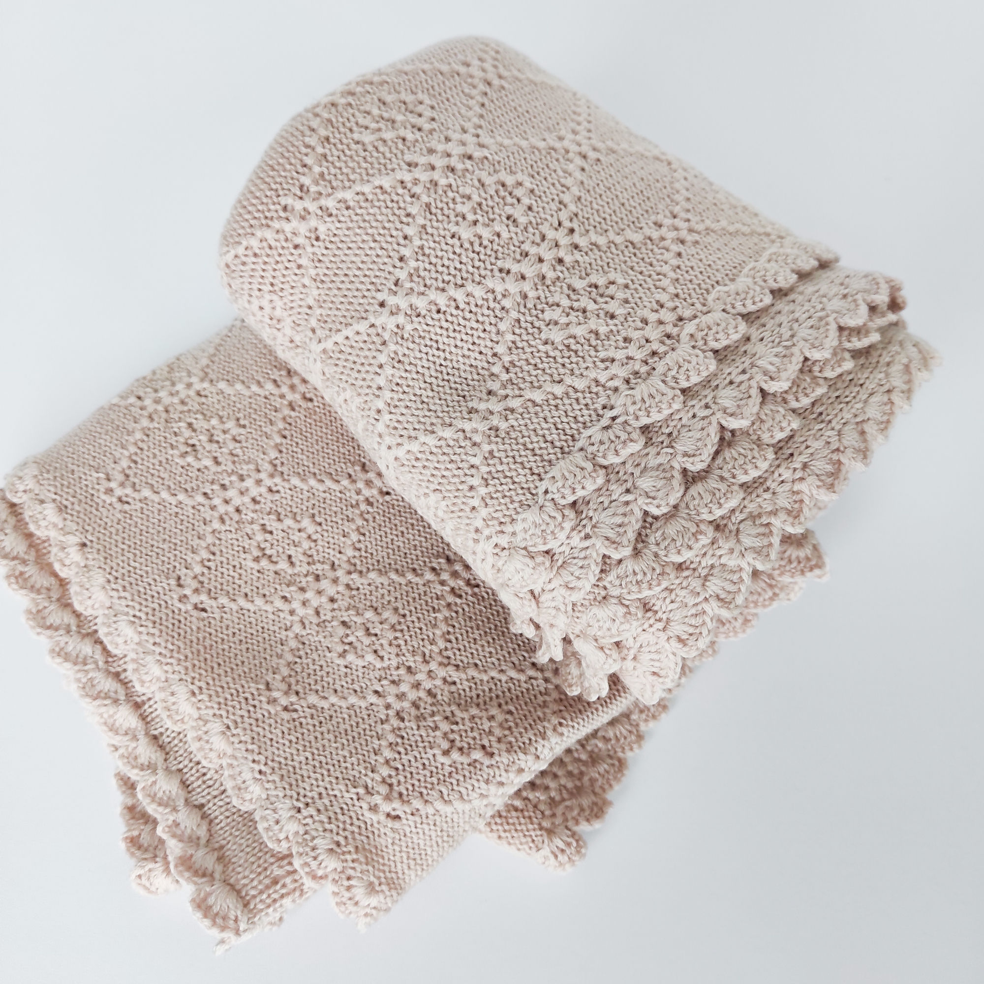 Beige baby blanket knit of soft merino wool