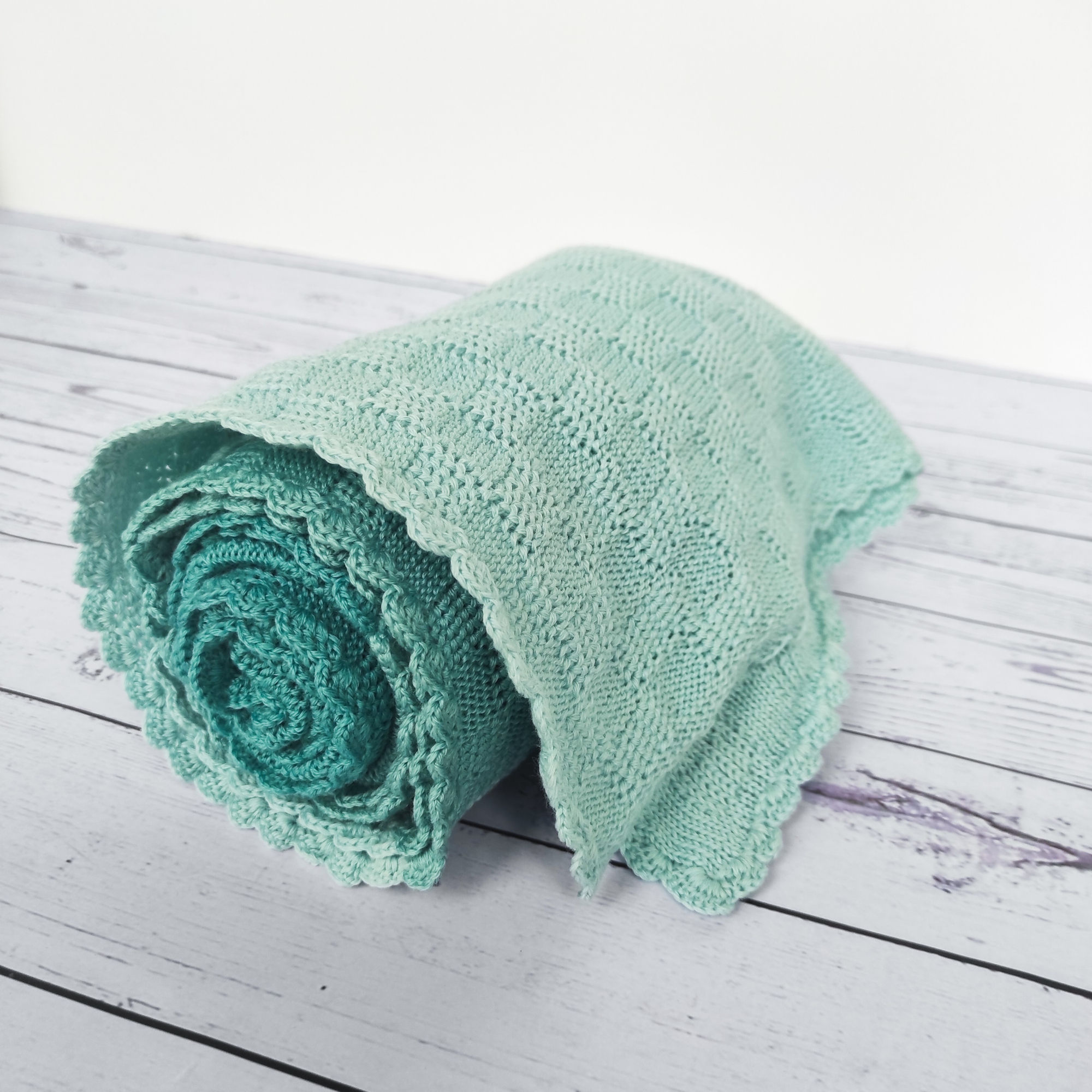 Tricolor baby blanket knitted of merino wool