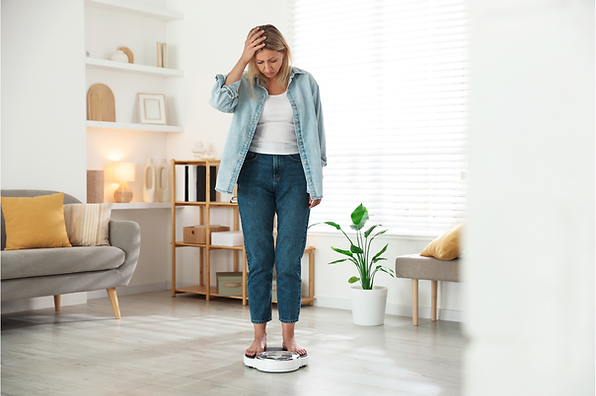 Woman on a scale with weight gain in menopause.