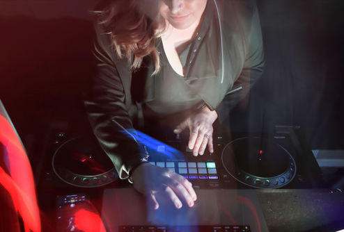 DJ Lindsay mixing music on a console 