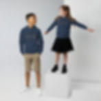 Two kids wearing navy hoodies with gray text, Kids eco hoodie, standing on a cube.