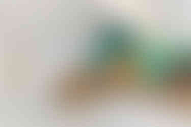 attic room with green accent wall, wooden furniture and clean aesthetic