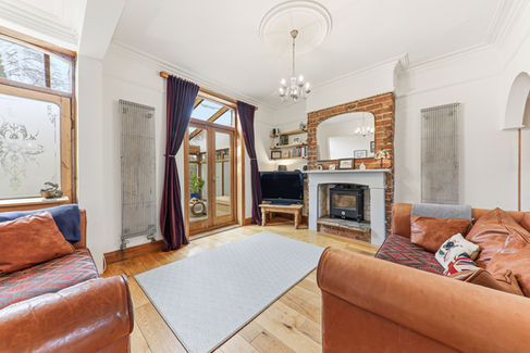 cozy lounge with rug, fireplace and leather sofas
