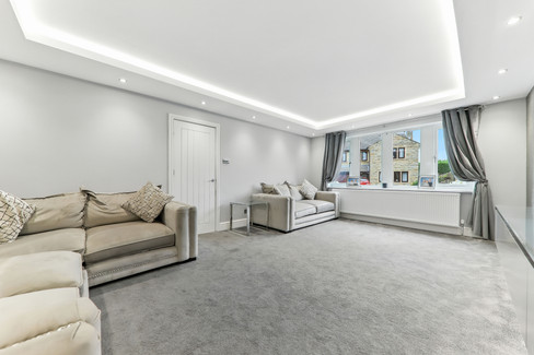 grey, white and cream coloured lounge with lights in the ceiling