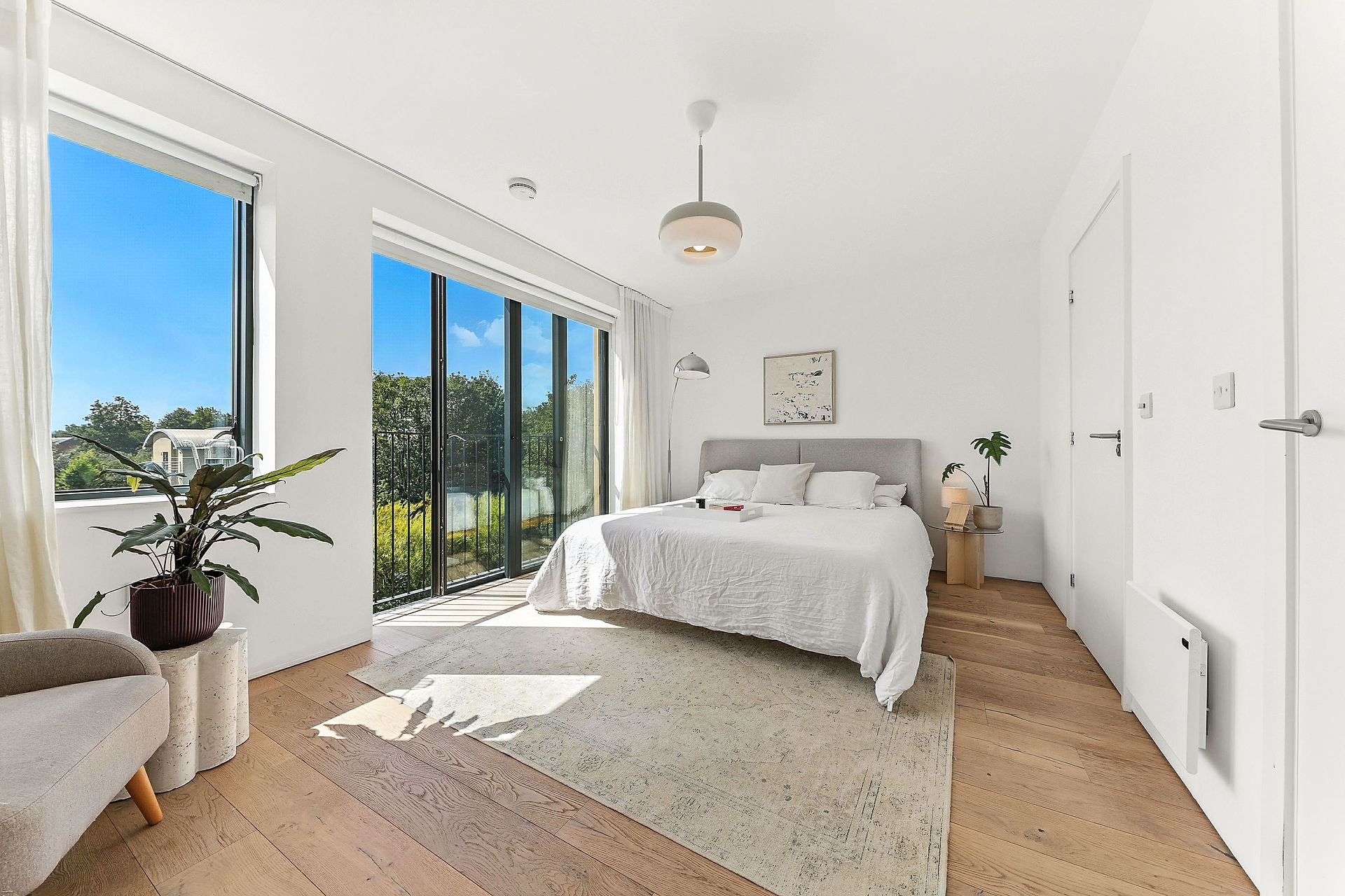large modern clean bedroom, white walls and plain decor