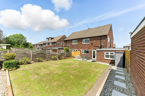 well maintained garden lawn with red brick semi detached house