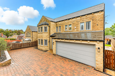 stone house large with double garage and paved driveway