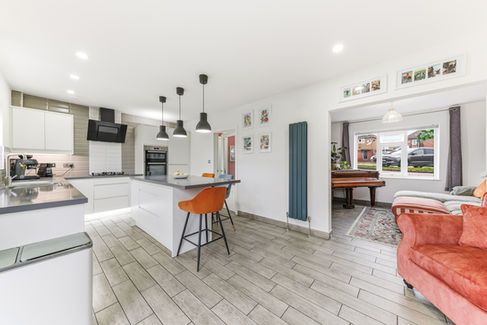 Large open kitchen with island and orange bar stools
