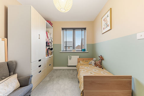 Nursery room with small bed and wardrobe