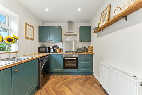 Stylish kitchen, dark blue painted cabinets with wooden tops