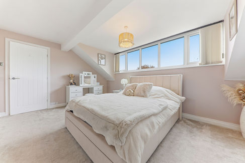 Double bedroom, clean white carpet and bedding