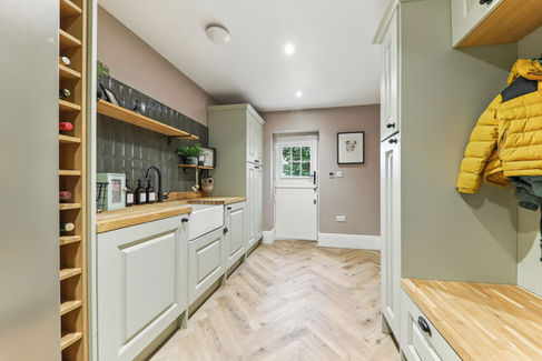 utility room with wooden surfaces, lime green cabinets