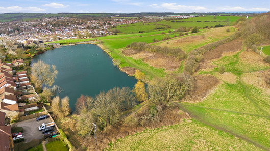 Ariel view of lake behind a road of houses