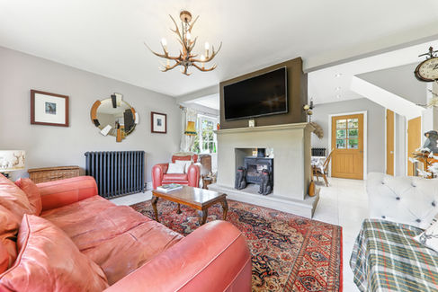 open plan lounge, red sofa and checked pattern run