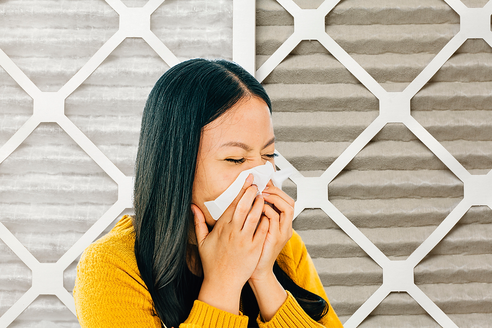 woman blowing into a tissue in foreground with clean (left) and dirty (right) filter in background