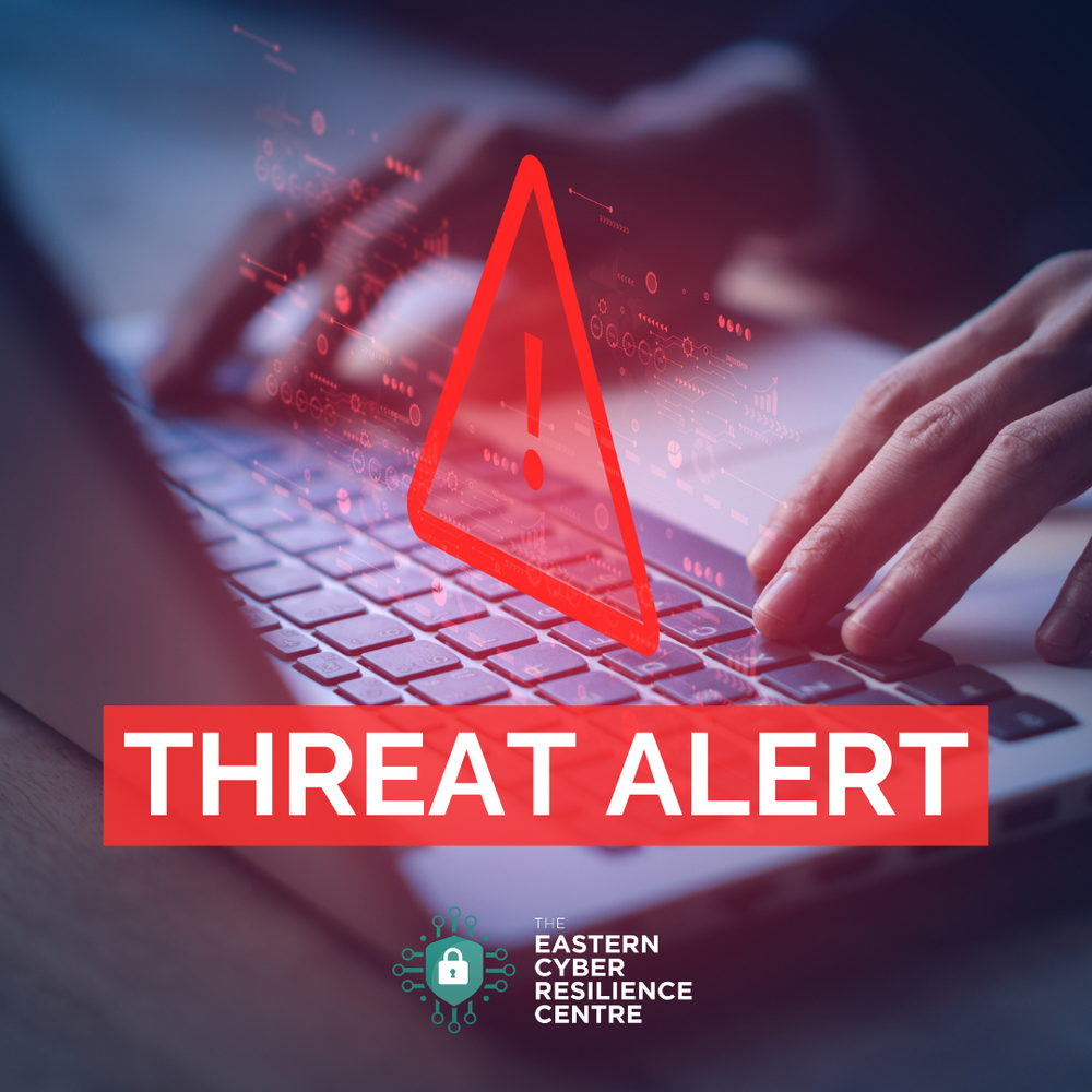 laptop with warning sign and text reading threat alert