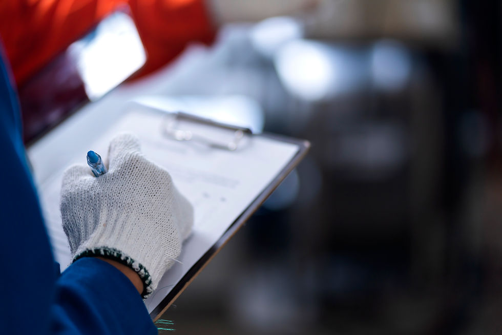 person wearing gloves holding a clipboard and a pen.