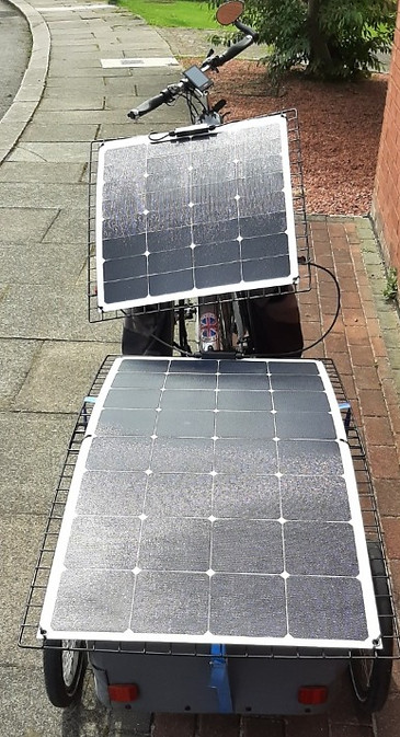 A 100W and 50W panel mounted on bike and trailer and connected in series to provide battery charging on a bike touring rig.