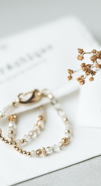 Close-up of handmade jewellery with natural gemstones in soft warm tones