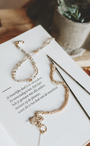 Close-up of handmade jewellery with natural gemstones in soft warm tones