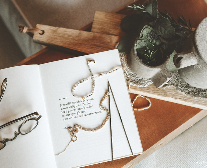 Soft styled scene with handmade jewellery, yarn and calm home decor.
