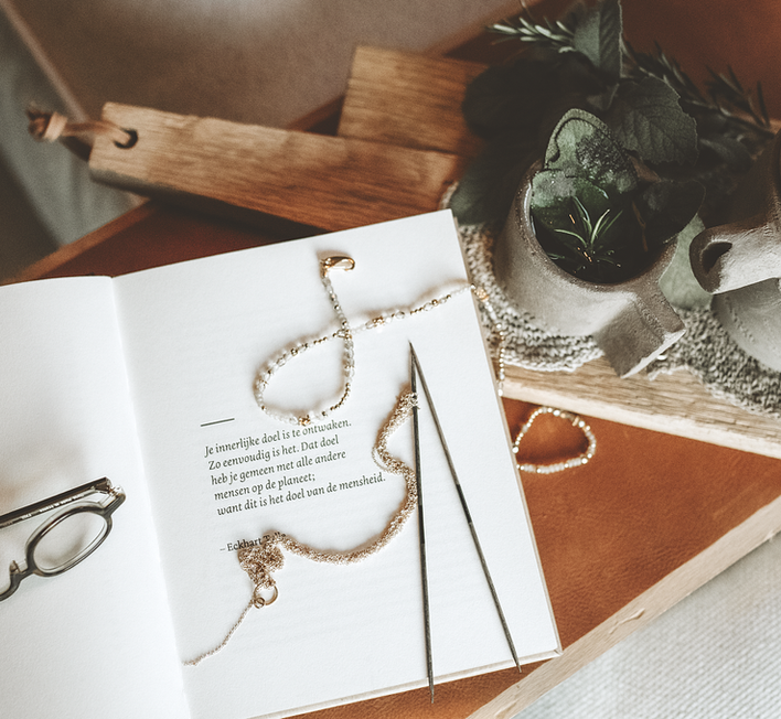 Soft styled scene with handmade jewellery, yarn and calm home decor.