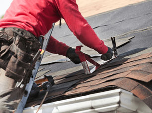 Roofer fitting shingles