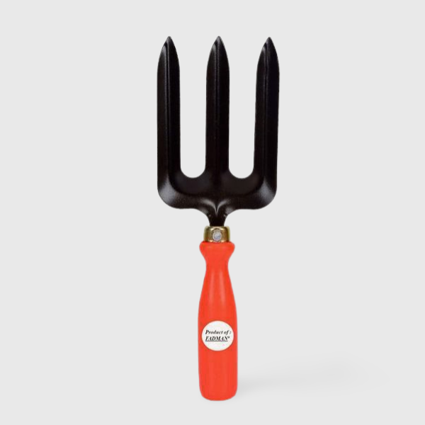 A metal garden tool with four sharp prongs, known as a fork, used for digging and turning soil.