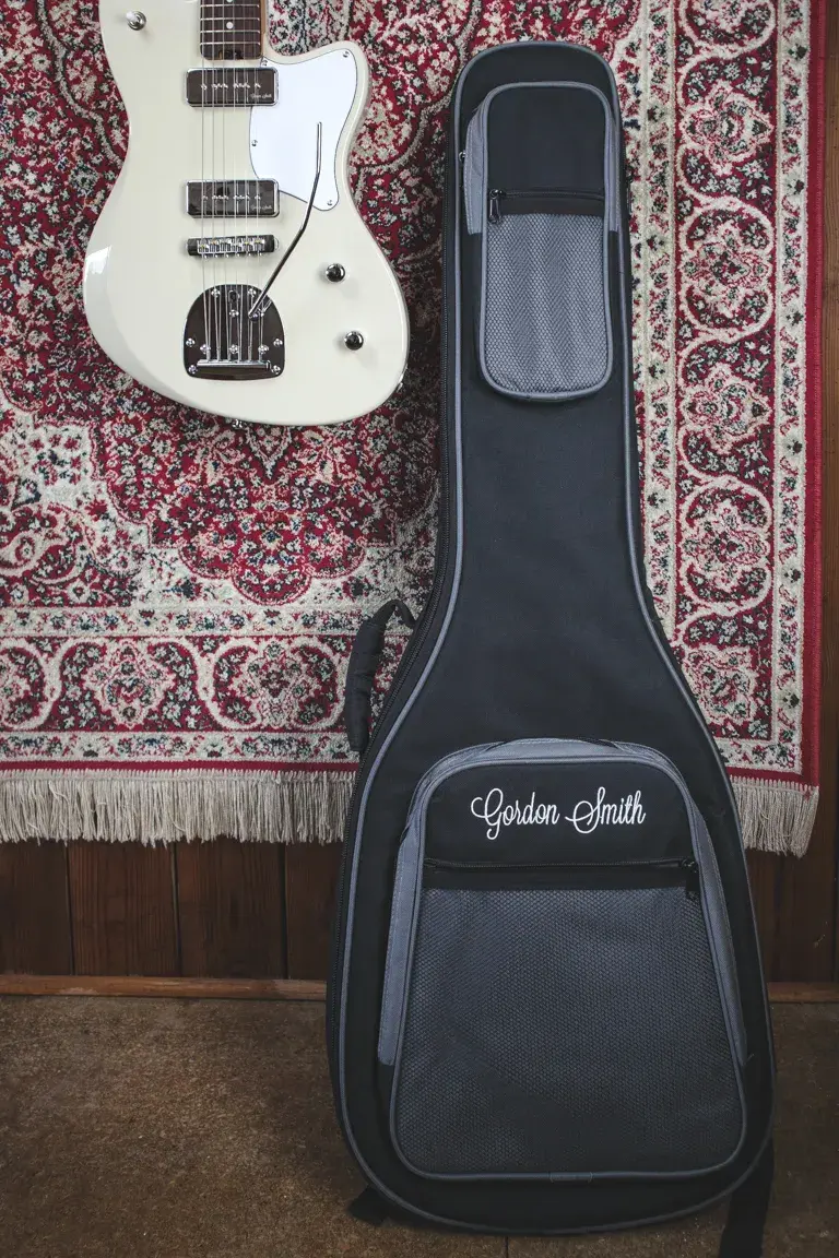 Thumbnail: Full shot of the guitar alongside its official Gordon Smith gig bag.