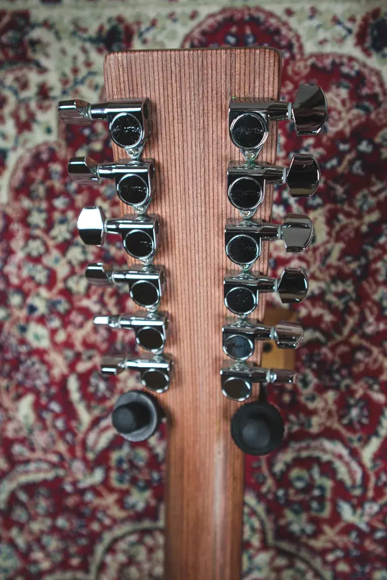 Thumbnail: Rear close-up of the headstock on a Martin D12X1 12-string acoustic guitar, showing chrome tuners.