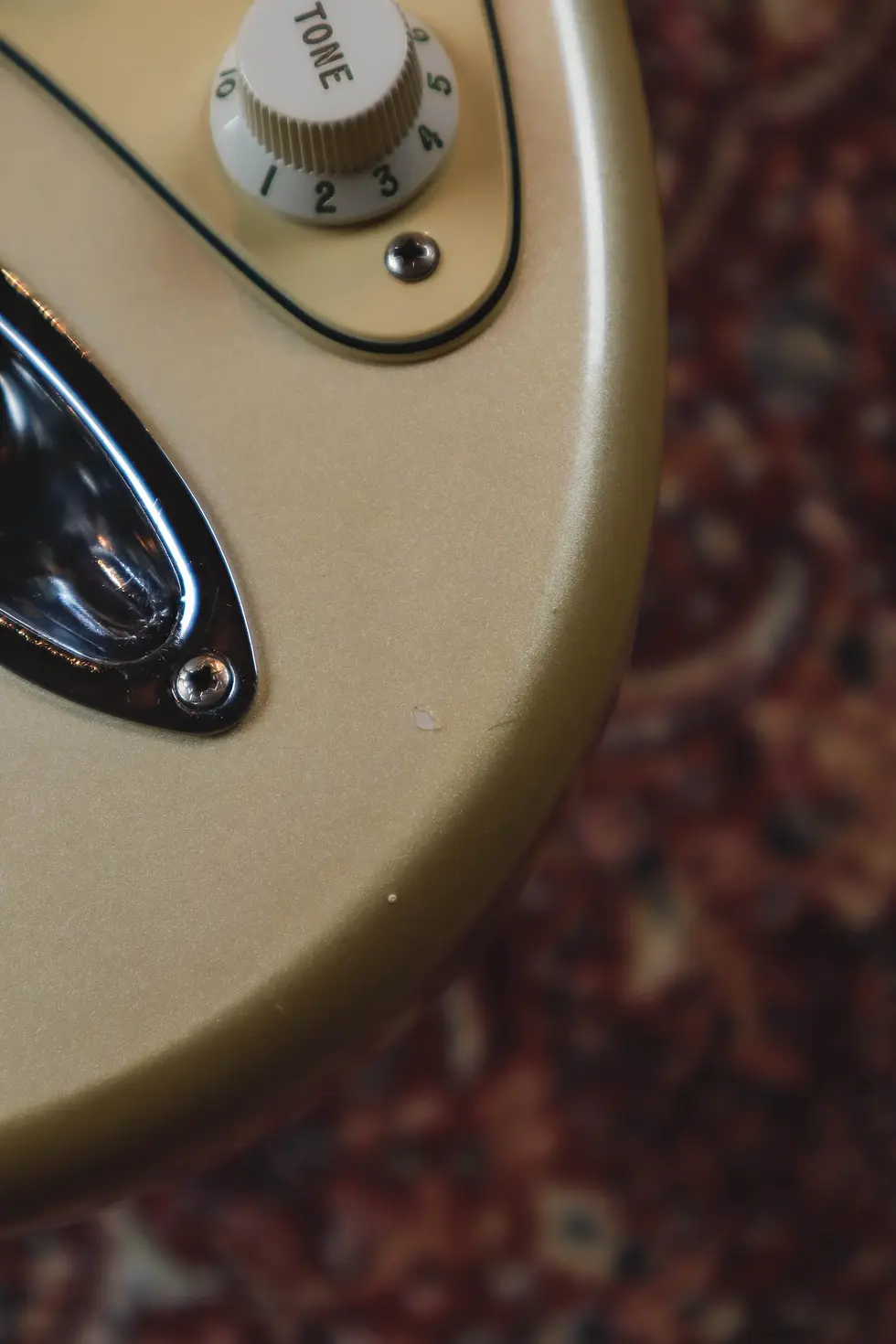 Thumbnail: Fender Stratocaster body edge lacquer chip close up near jack