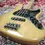 Thumbnail: Angled view of 2011 Fender USA Jazz Deluxe Bass in natural finish on carpet