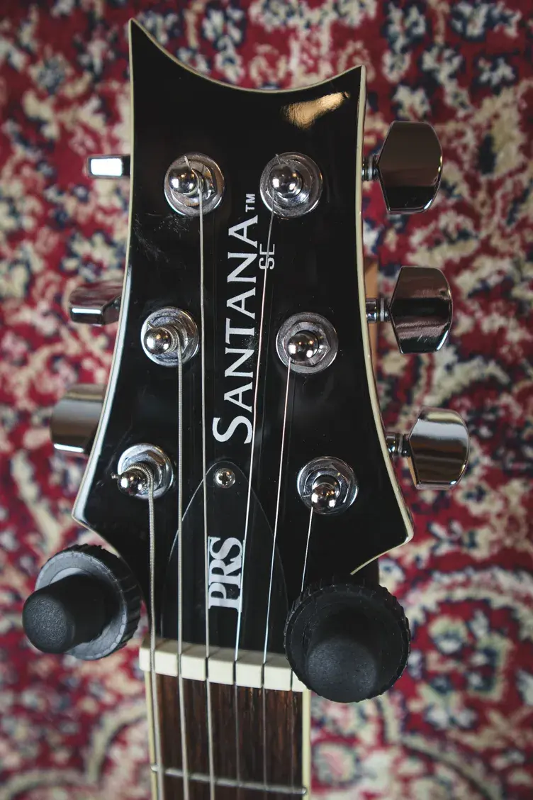 Thumbnail: PRS SE Santana front headstock showing logo and tuners
