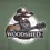 Thumbnail: Close-up of The Woodshed Americana graphic printed on sage green T-shirt