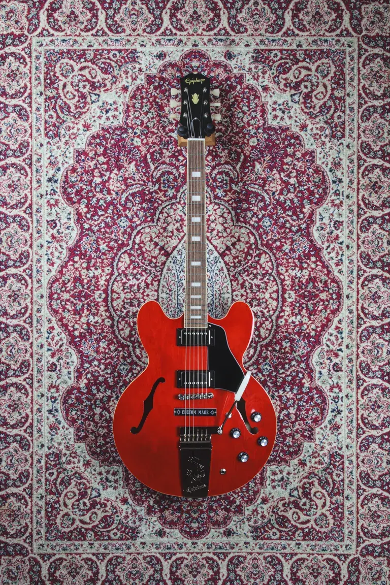 Front full-length shot of Epiphone Joe Bonamassa ES-335 in Sixties Cherry with “Custom Made” plaque