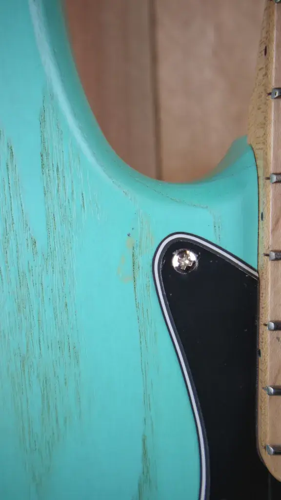Thumbnail: Close-up of defects in the paintwork on the body of the Marco Bass N1 Bass Guitar in Seafoam Green.d