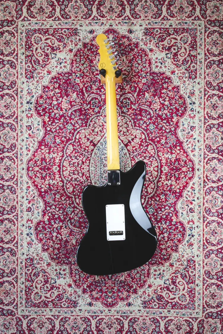 Full rear view of G&L Doheny Tribute showing contoured black body and maple neck