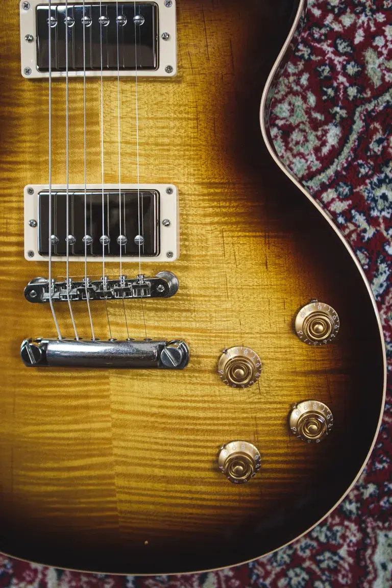 Thumbnail: Close-up of flame maple top with bridge, pickups, and control knobs on Gibson Les Paul Traditional