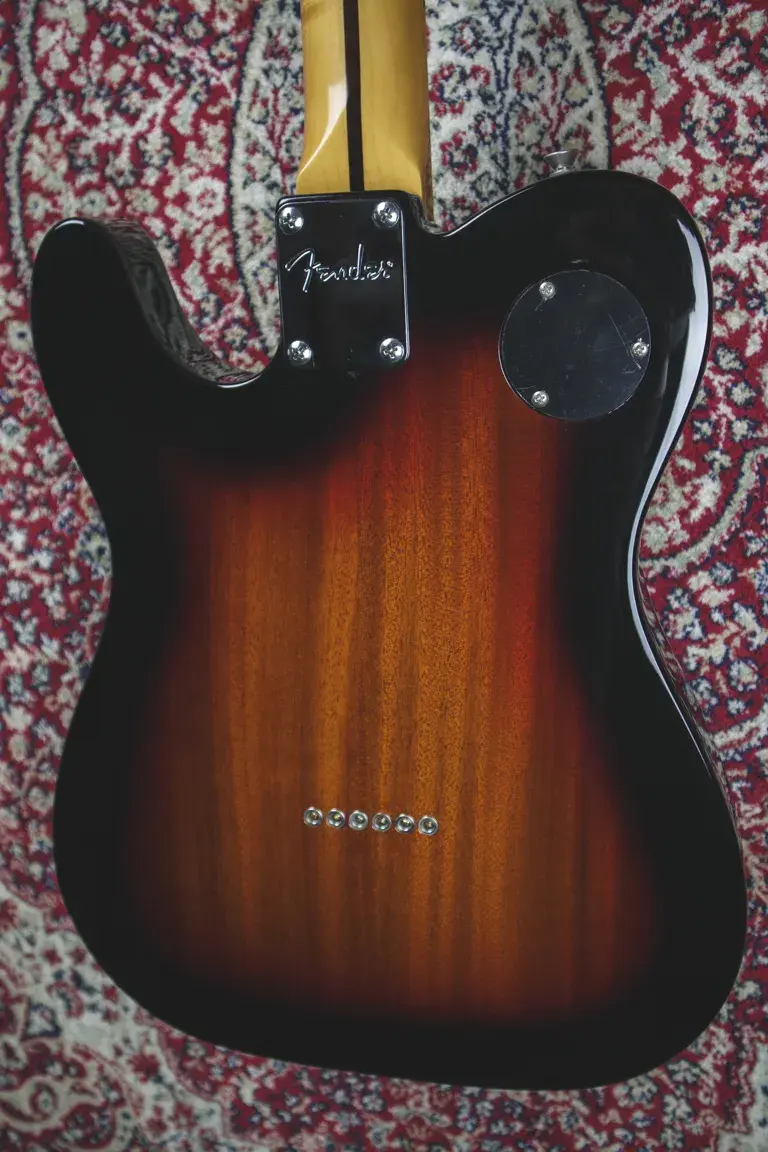 Thumbnail: Back close-up of Fender neck plate and through-body string ferrules.