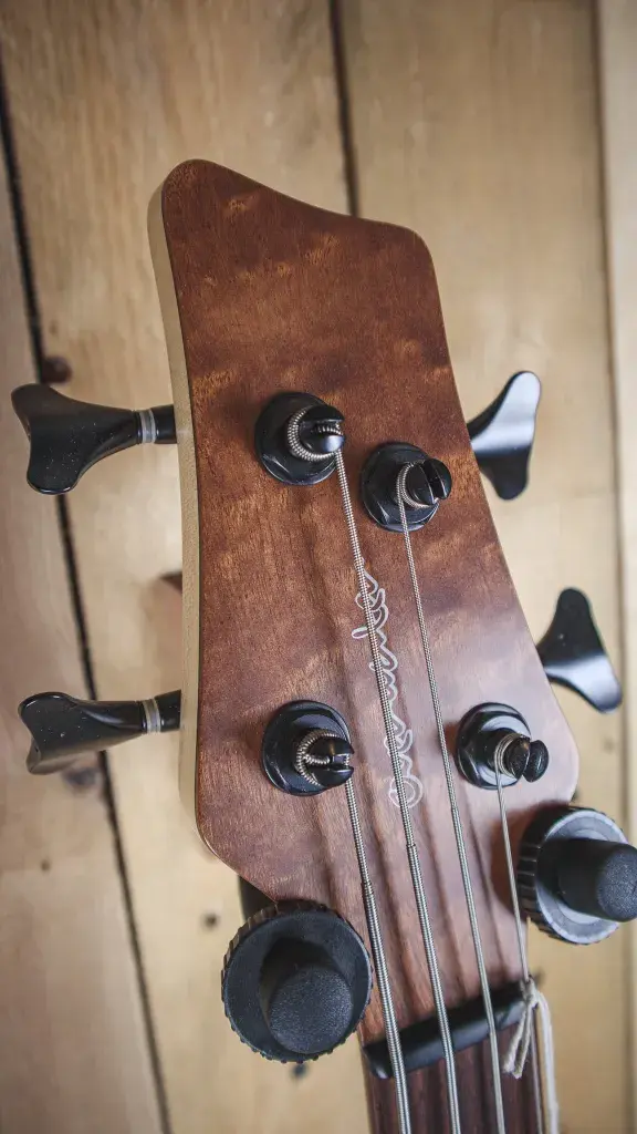 Thumbnail: Close-up of the headstock, featuring the Overwater logo and tuning pegs.